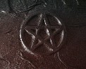(Close-up of black witch's pentacle)